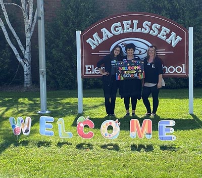 teachers holding welcome sign