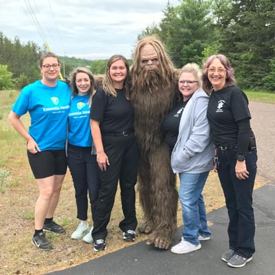 group poses with sasquach