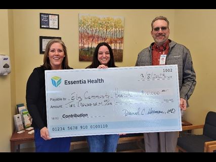 group holding oversized check