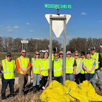 volunteers outdoors in yellow vests