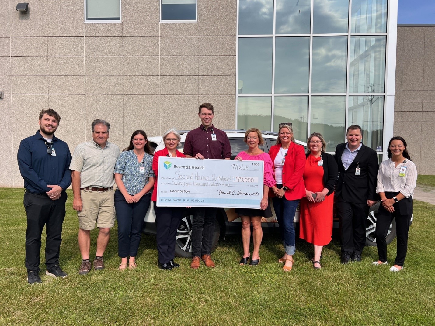 Group Of People Holding Huge Check