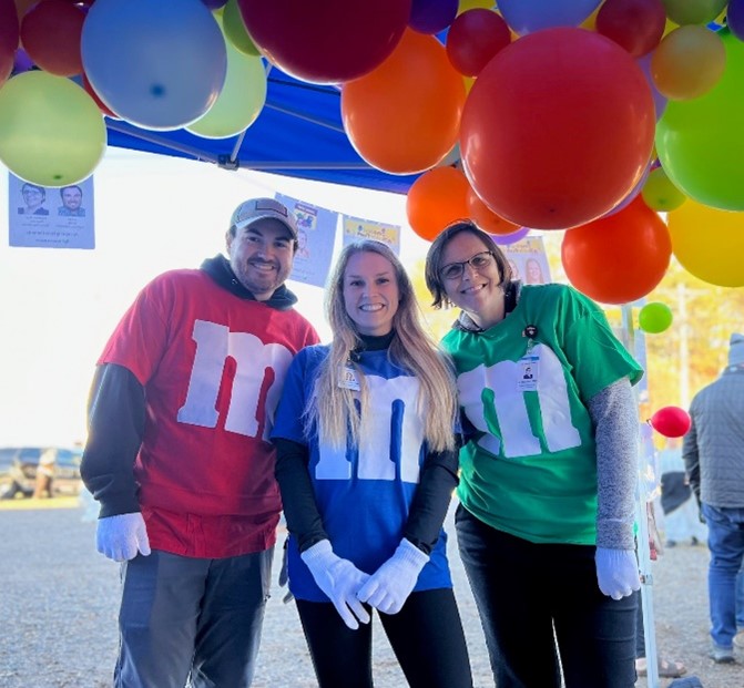 group of 3 colleagues sorrounded with balloons
