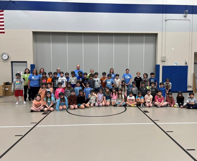 Some Essentia staffs and multiple kids in a group picture