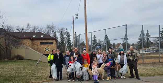 Essentia volunteers holding trash bags containg trash