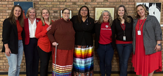 A group of Essentia employes in red and black dress code.